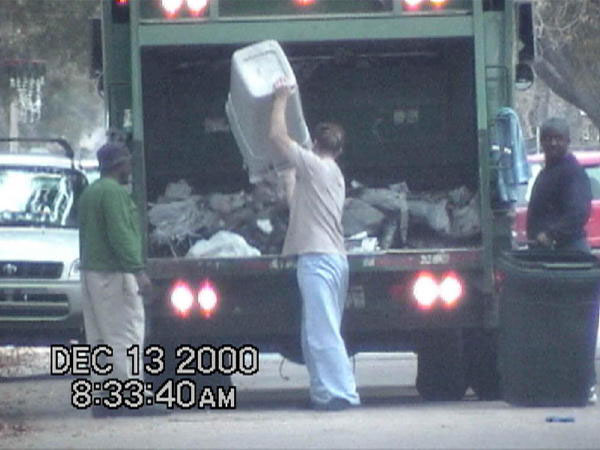 Person Lifting a Trash Can